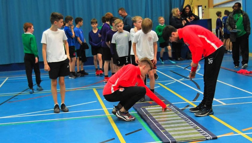 Coleg Cambria students help Flintshire pupils go for gold at athletics festival