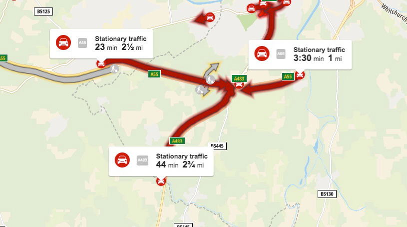 Long delays on A55 near Posthouse roundabout due to a collision or issues with traffic lights